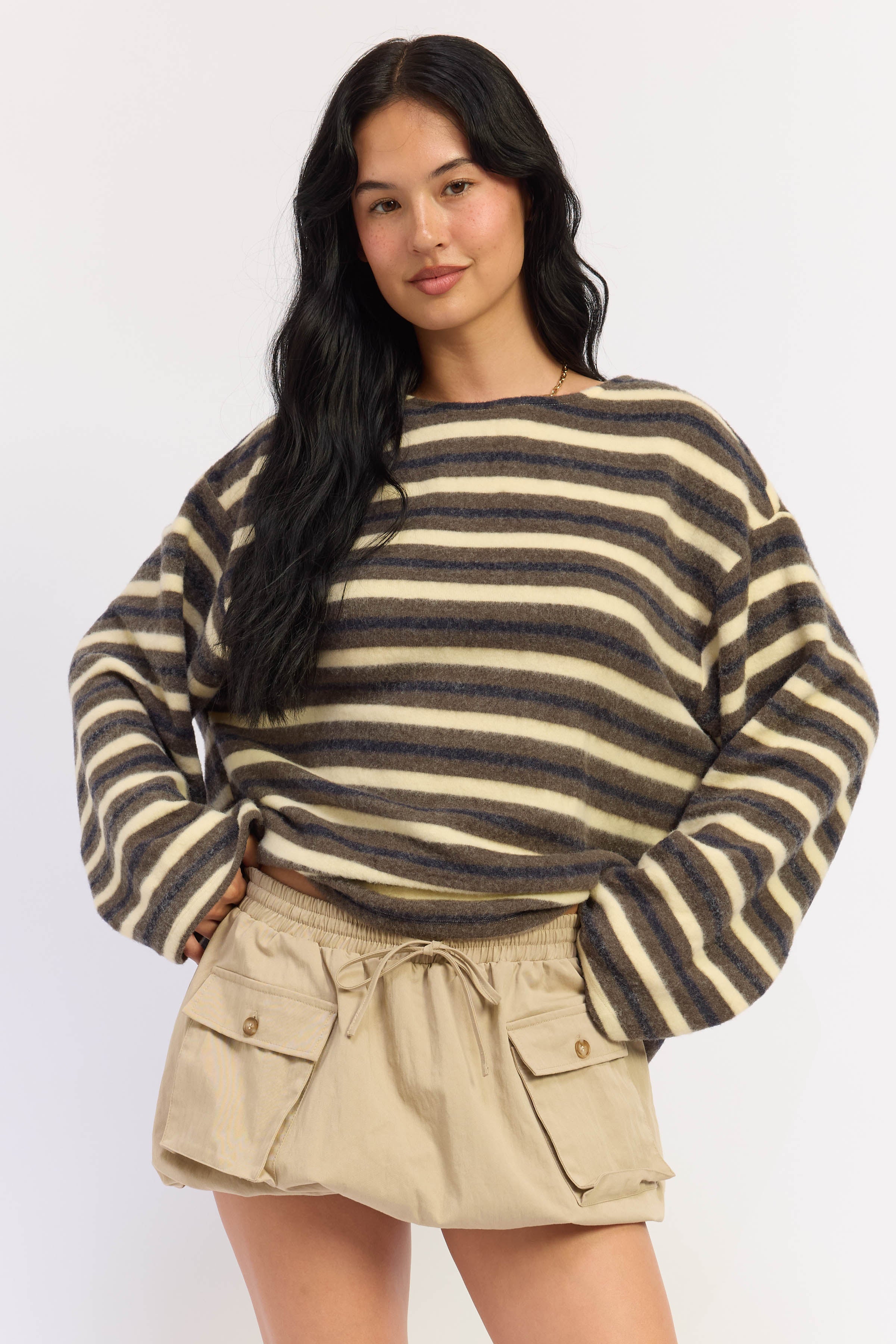 Oversized striped sweater in navy, olive and cream with dropped shoulders and long sleeves, front view.
