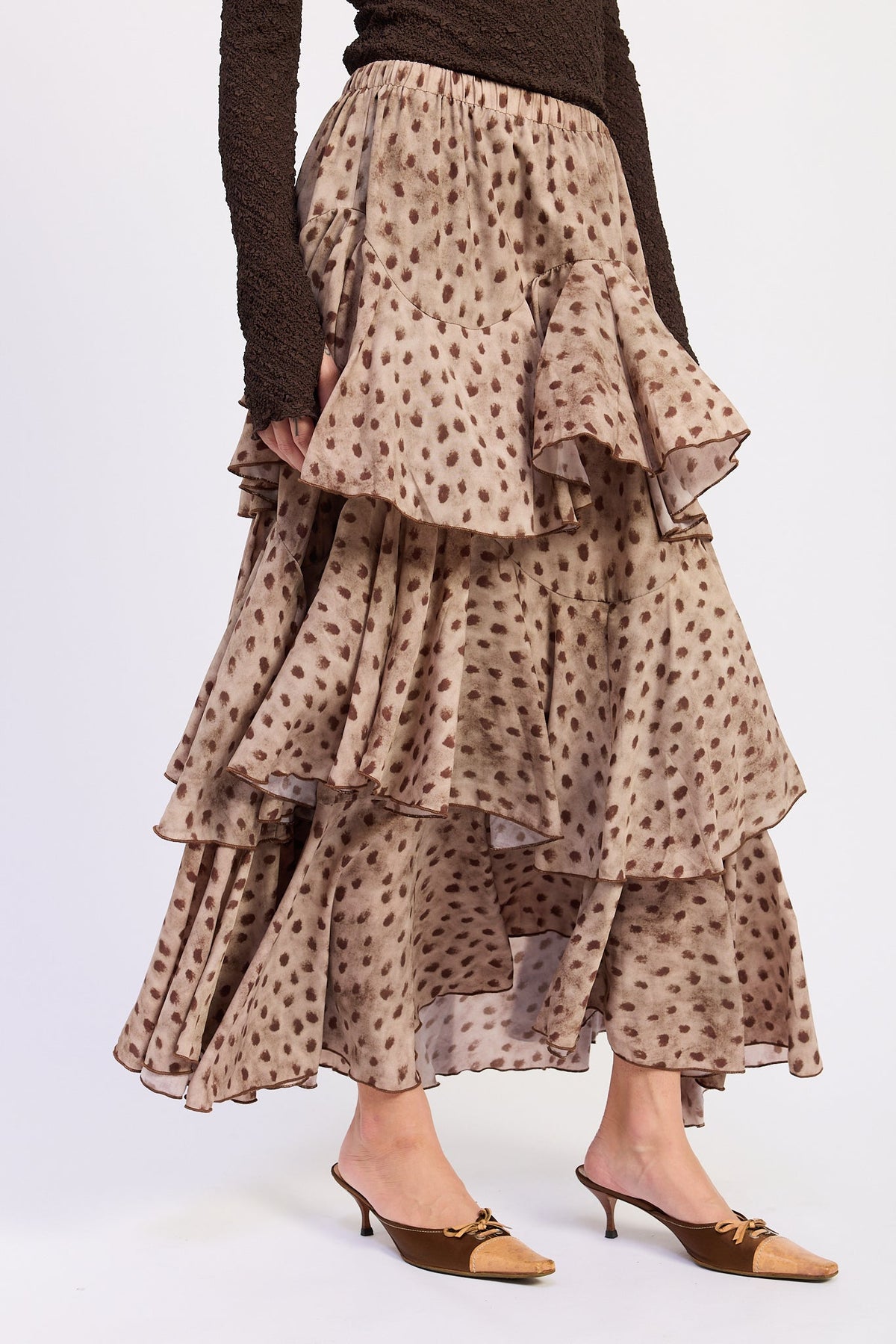 Side view of Sahara Spotted Ruffle Maxi Skirt showing overlapping ruffle tiers and elastic waistband.