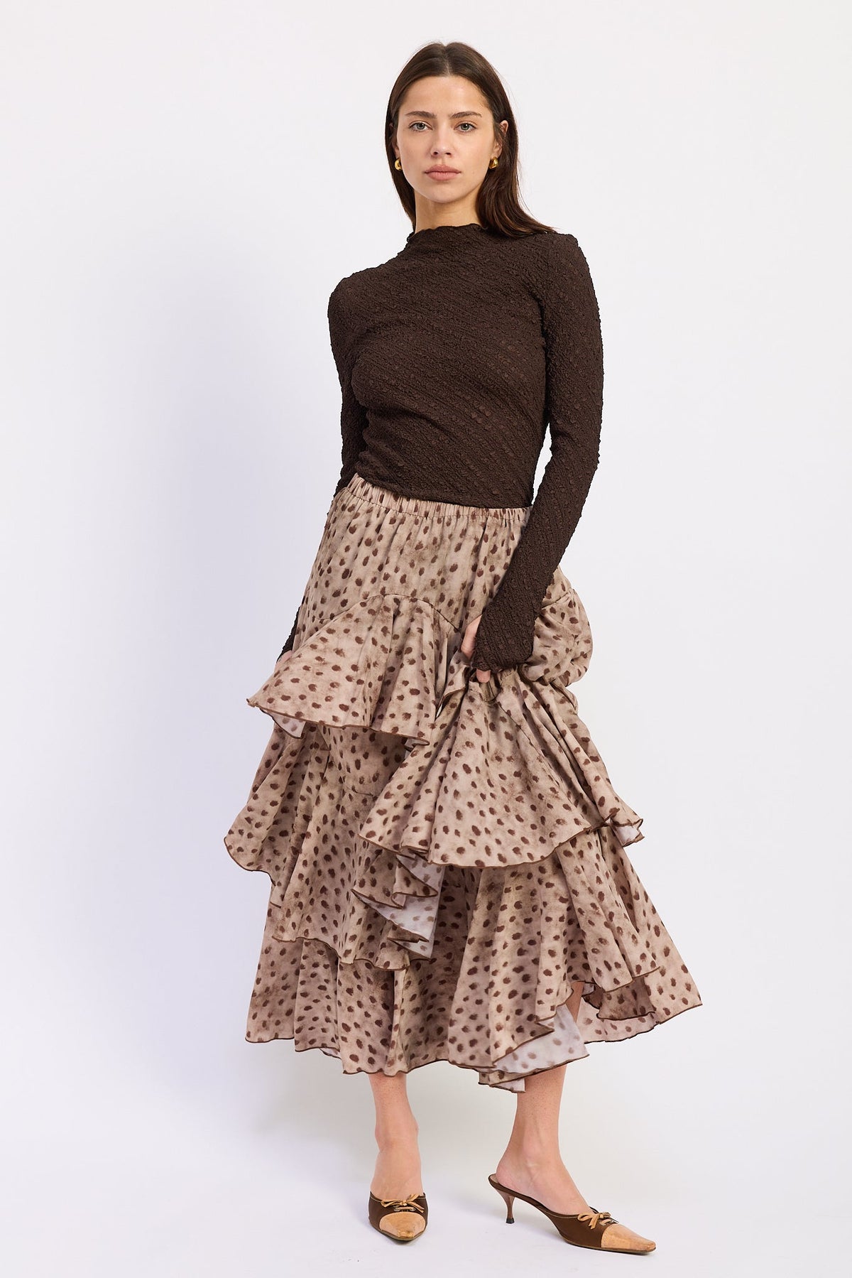 Sahara Spotted Ruffle Maxi Skirt styled with a chocolate brown long sleeve top, front view.