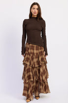 Maplewood Plaid Ruffle Maxi Skirt in brown and tan with layered chiffon tiers, styled with a chocolate brown long sleeve top.