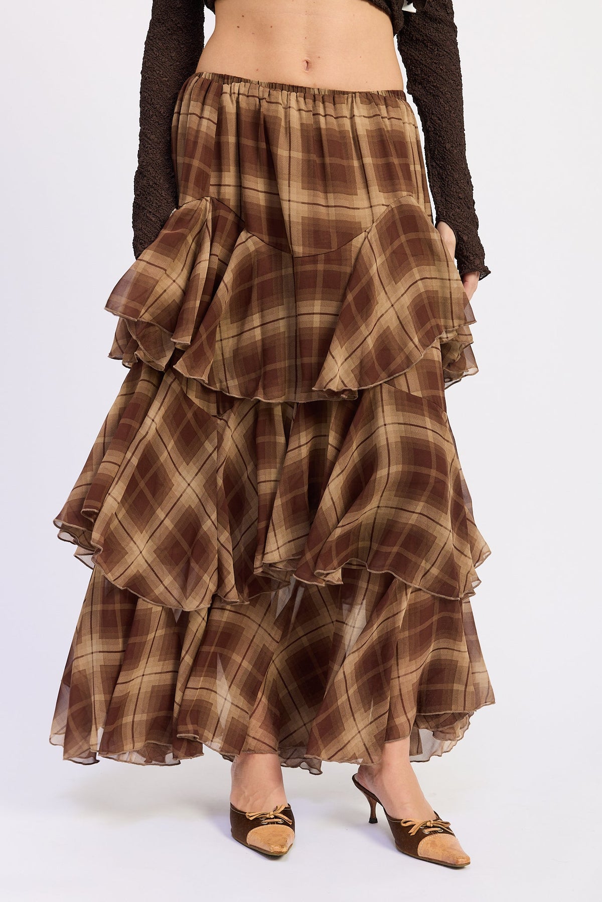 1. Front detail of Maplewood Plaid Ruffle Maxi Skirt showing elastic waistband, brown and tan plaid and tiered chiffon layers.