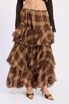 1. Front detail of Maplewood Plaid Ruffle Maxi Skirt showing elastic waistband, brown and tan plaid and tiered chiffon layers.