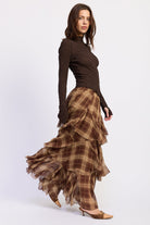 Side view of Maplewood Plaid Ruffle Maxi Skirt showing brown plaid pattern and layered ruffles.