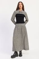 Thea black and ivory layered plaid collared top with fitted black contrast knit body, styled with the matching skirt.