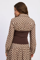 Back view of Thea espresso and ivory plaid top with fitted brown knit panel and collared shirt detail.