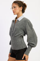Side view of charcoal gray Cambridge sweater showing gathered bust, shaped waist and voluminous sleeves.