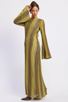 Angled view of Solstice Stripe Long Sleeve Maxi Dress showing textured stripes in olive, mustard, and brown with long flared sleeves.