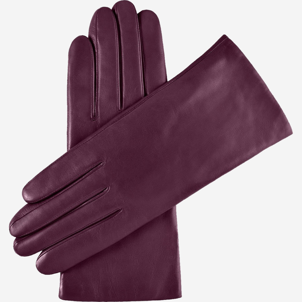 Pair of purple leather gloves on a white background