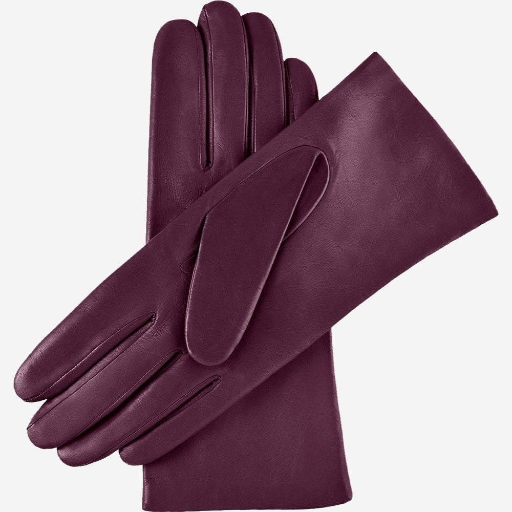 Pair of purple leather gloves on a light gray background