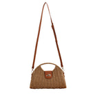 Straw crossbody bag with vegan leather and fixed top handle and removable crossbody strap complete with a fold over clasp and gold hardware, in khaki front view