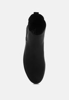 Black slip-on shoe on a white background