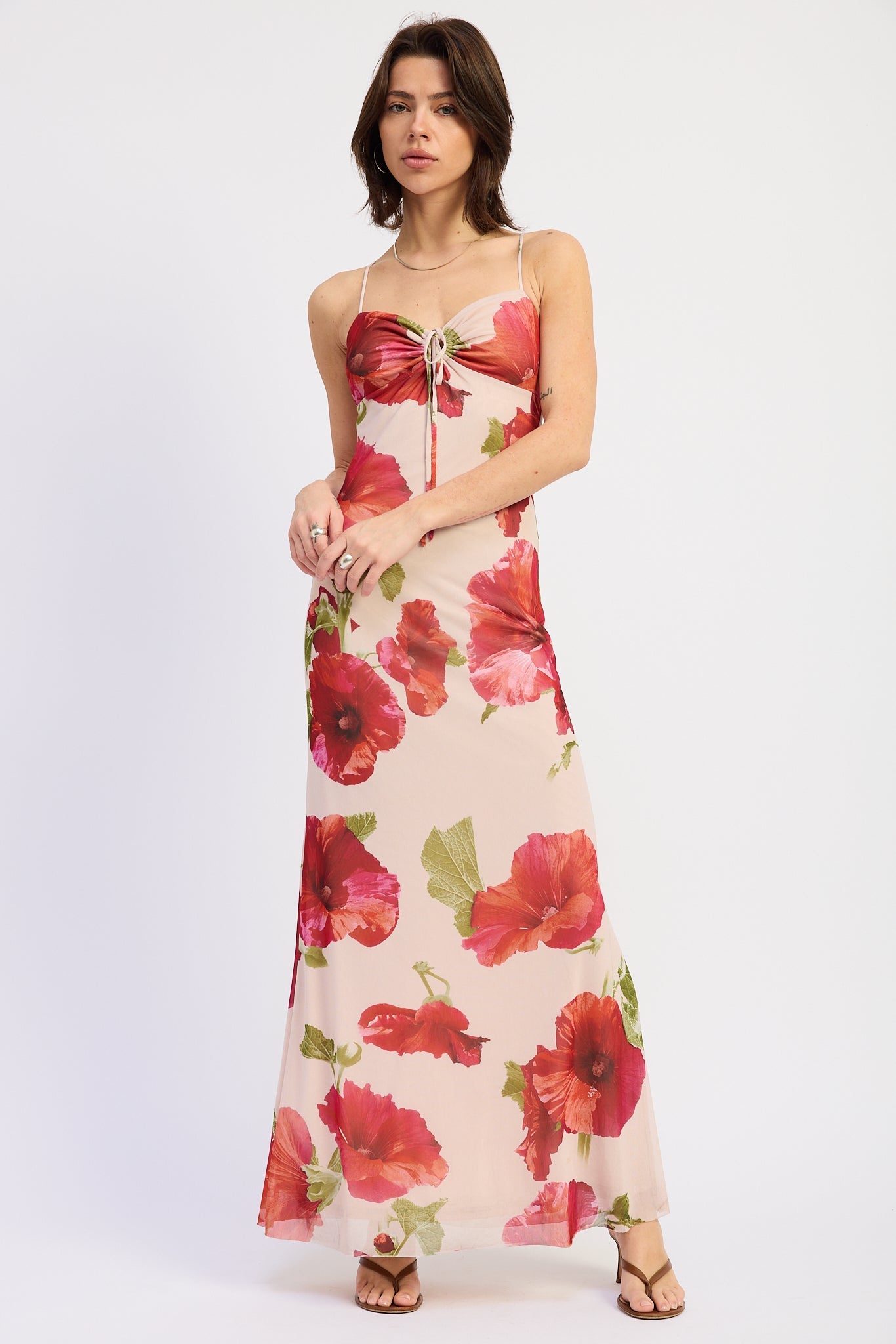 Full length front view of cream and red floral maxi dress styled with strappy sandals, AVAH