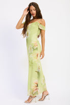 Side view of soft green floral off shoulder maxi dress with ruched sleeves and fitted silhouette
