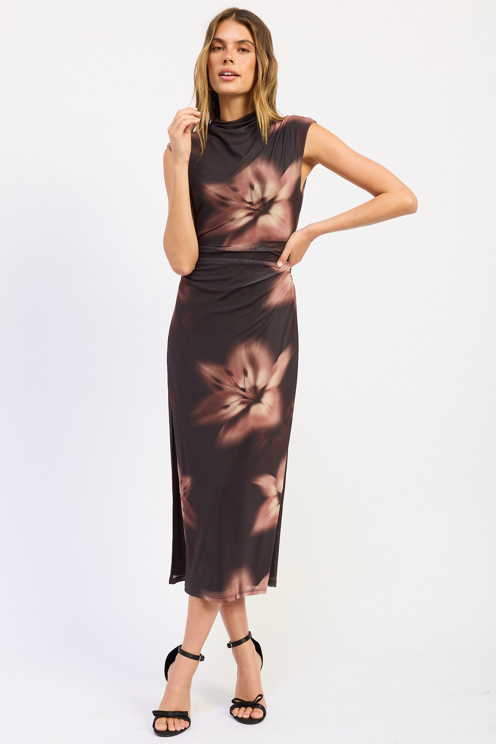 Front view of Ruched Midi Dress in chocolate brown with oversized flowers, sleeveless neckline and fitted silhouette.