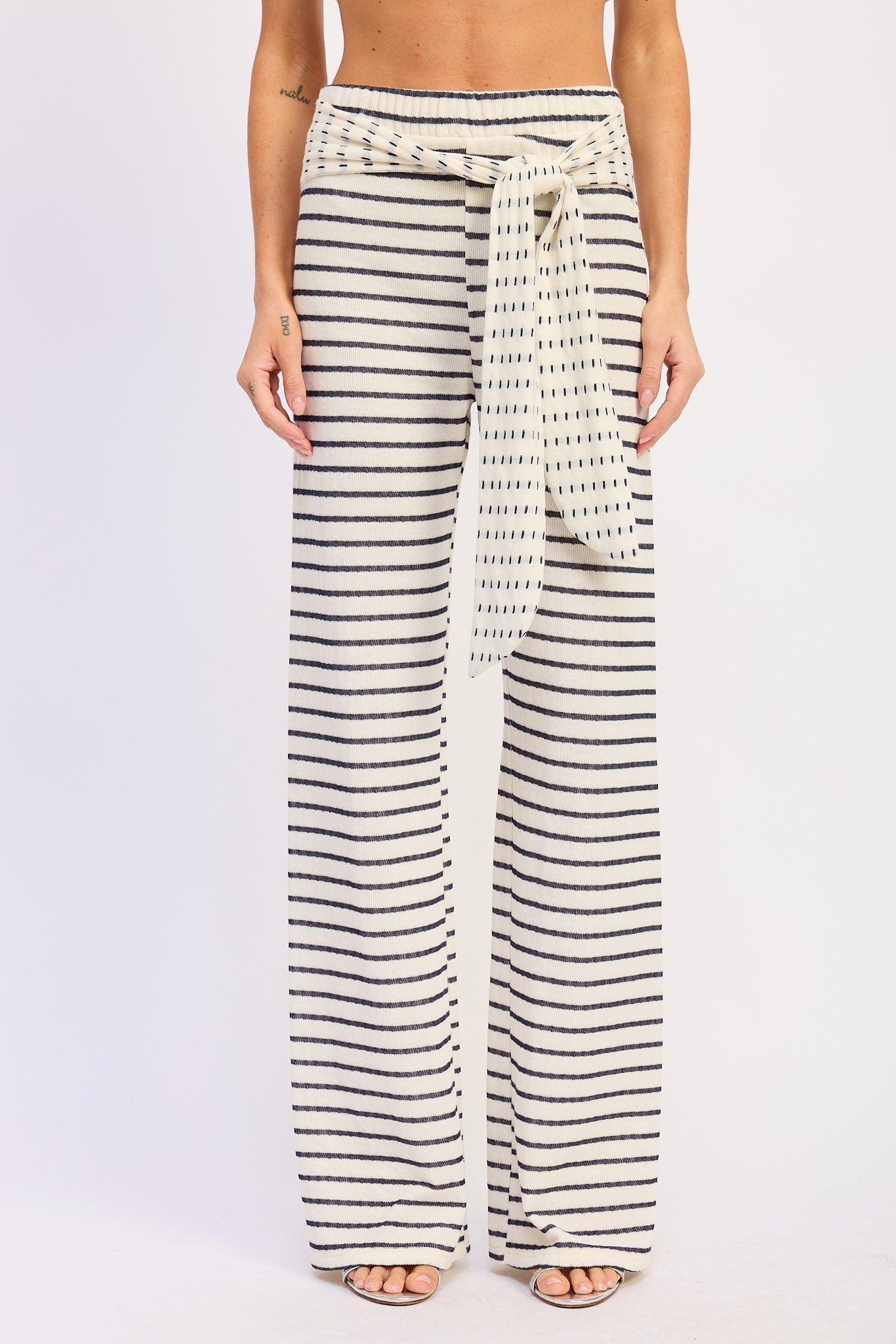 Woman wearing a black and white striped outfit on a white background