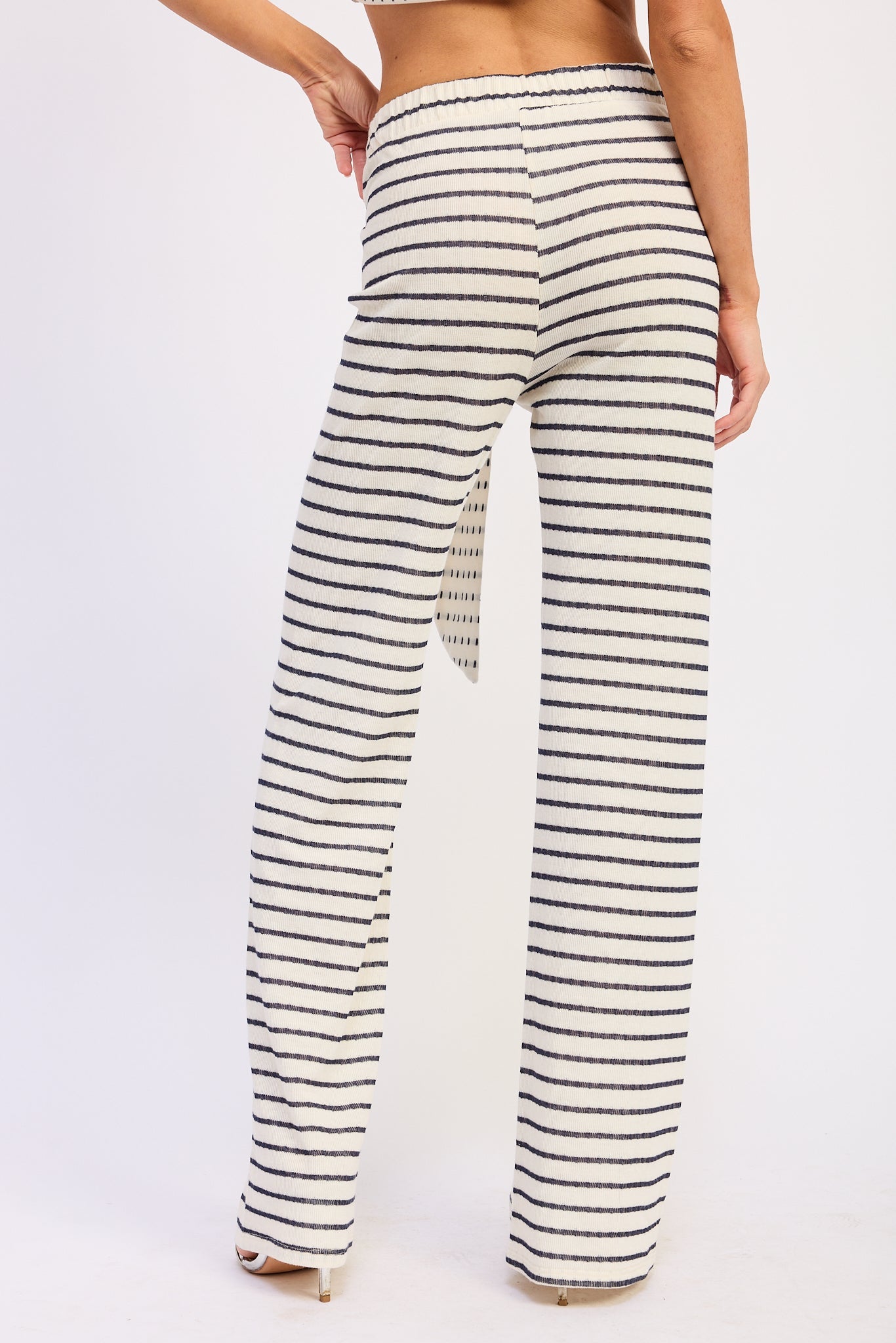 Woman wearing a black and white striped outfit on a white background