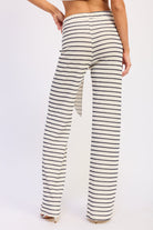 Woman wearing a black and white striped outfit on a white background