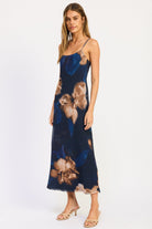 Angled front view of navy floral maxi dress showing scoop neckline, thin straps and streamlined silhouette.