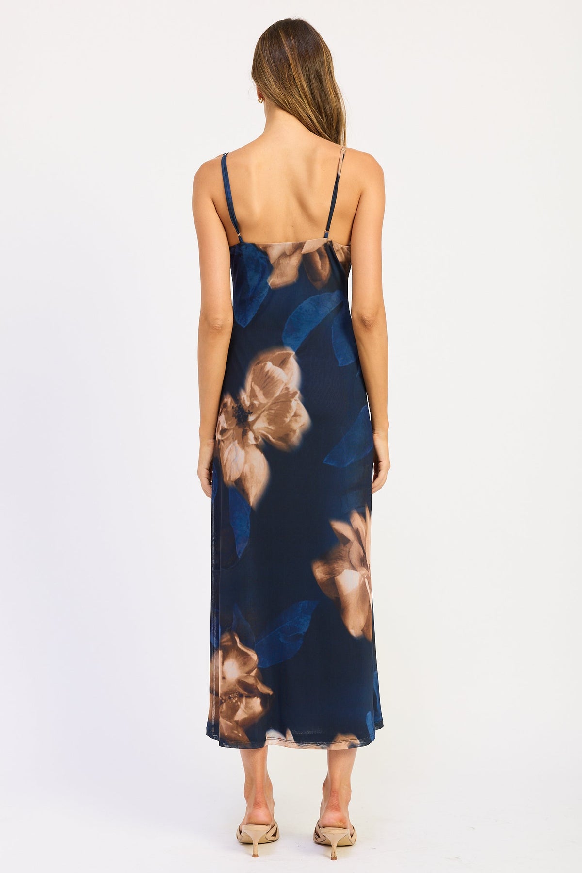 Back view of Midnight Bloom Floral Maxi Dress showing adjustable spaghetti straps and oversized blue and taupe floral print.