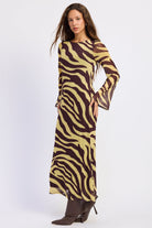 Side view of Sahara zebra print maxi dress with fitted silhouette and flared bell sleeves.