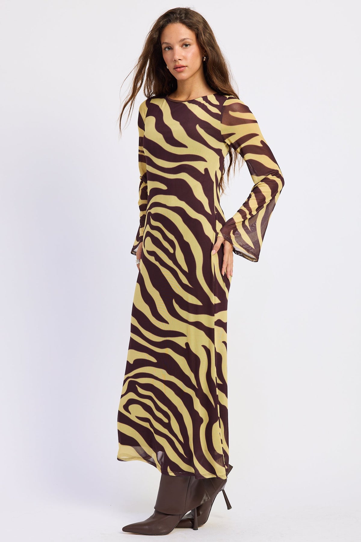 Side view of Sahara zebra print maxi dress with fitted silhouette and flared bell sleeves.