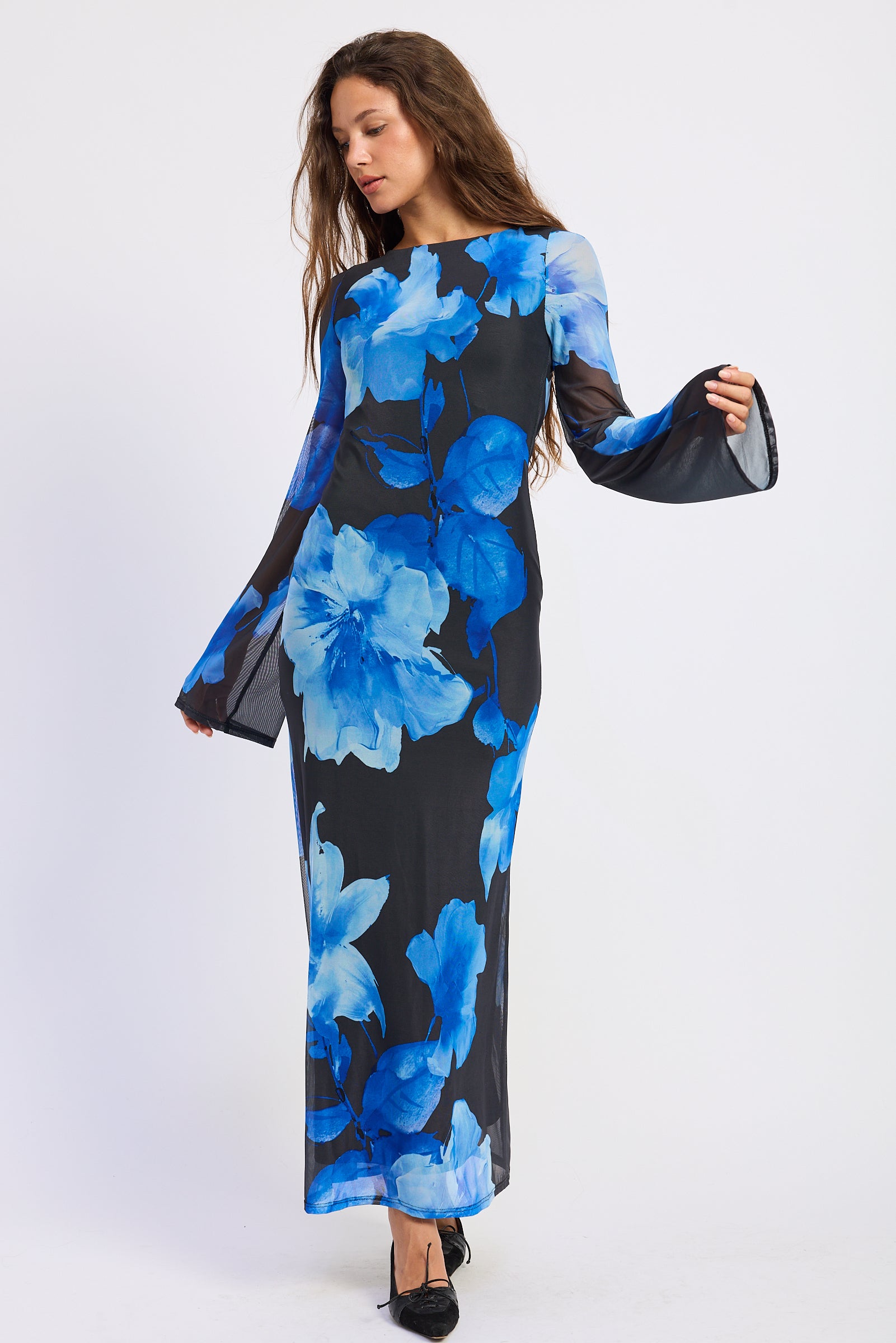 Floral Long Sleeve Maxi Dress in black with oversized electric blue flowers and dramatic open back, angled front view.