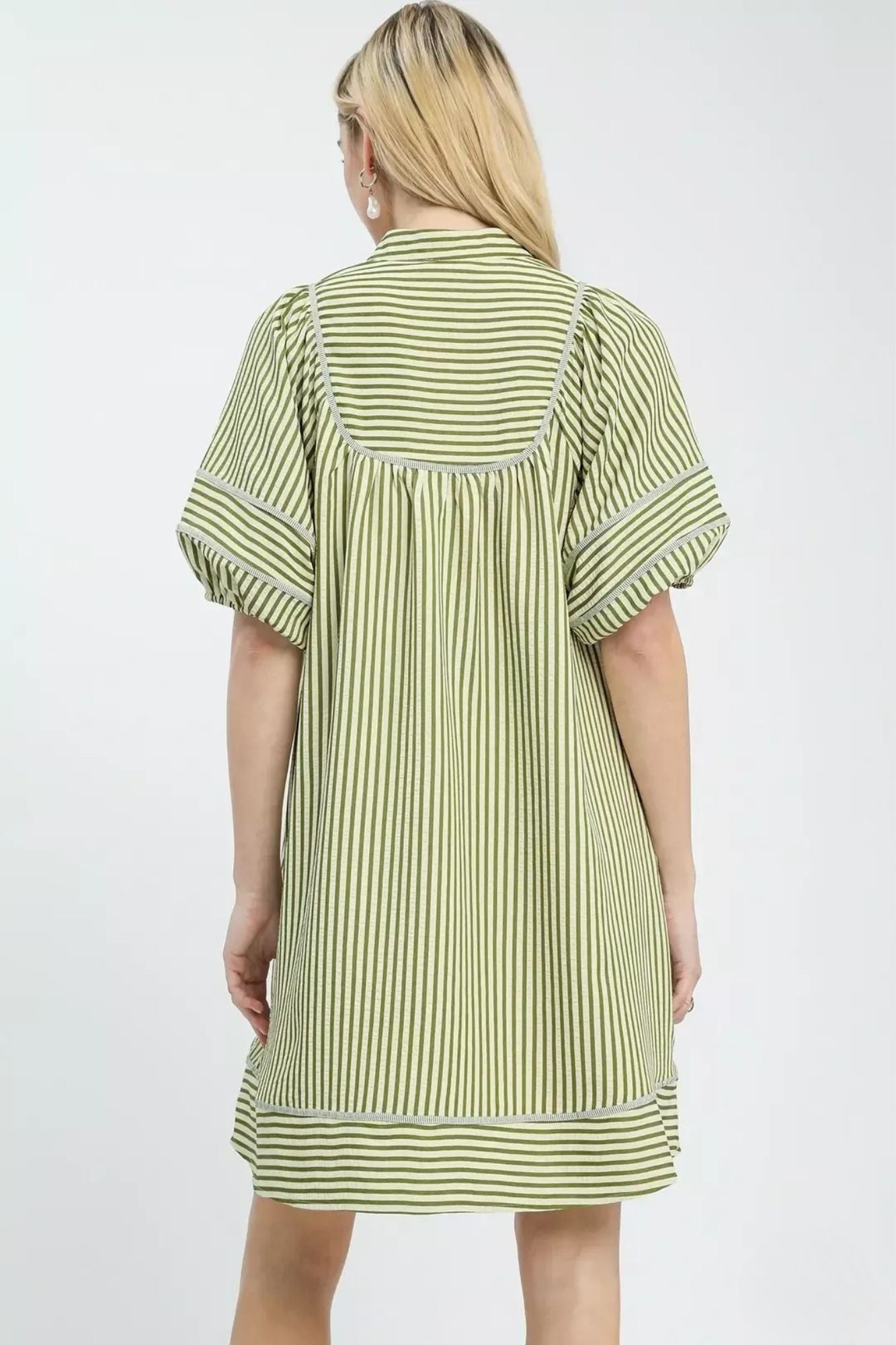 Back view of green stripe mini dress showing gathered yoke and contrast stitching, AVAH
