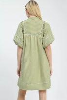 Back view of green stripe mini dress showing gathered yoke and contrast stitching, AVAH