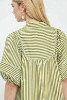 Close back detail of green stripe dress showing contrast topstitching and gathered yoke, AVAH
