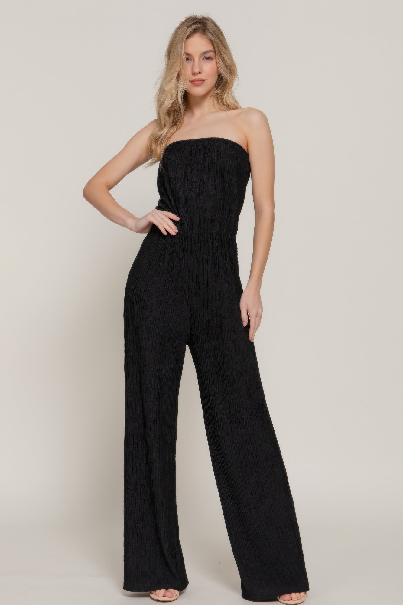 Front view of black strapless crinkle jumpsuit on model-AVAH