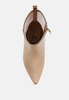 Beige ankle boot with a gold zipper on a white background