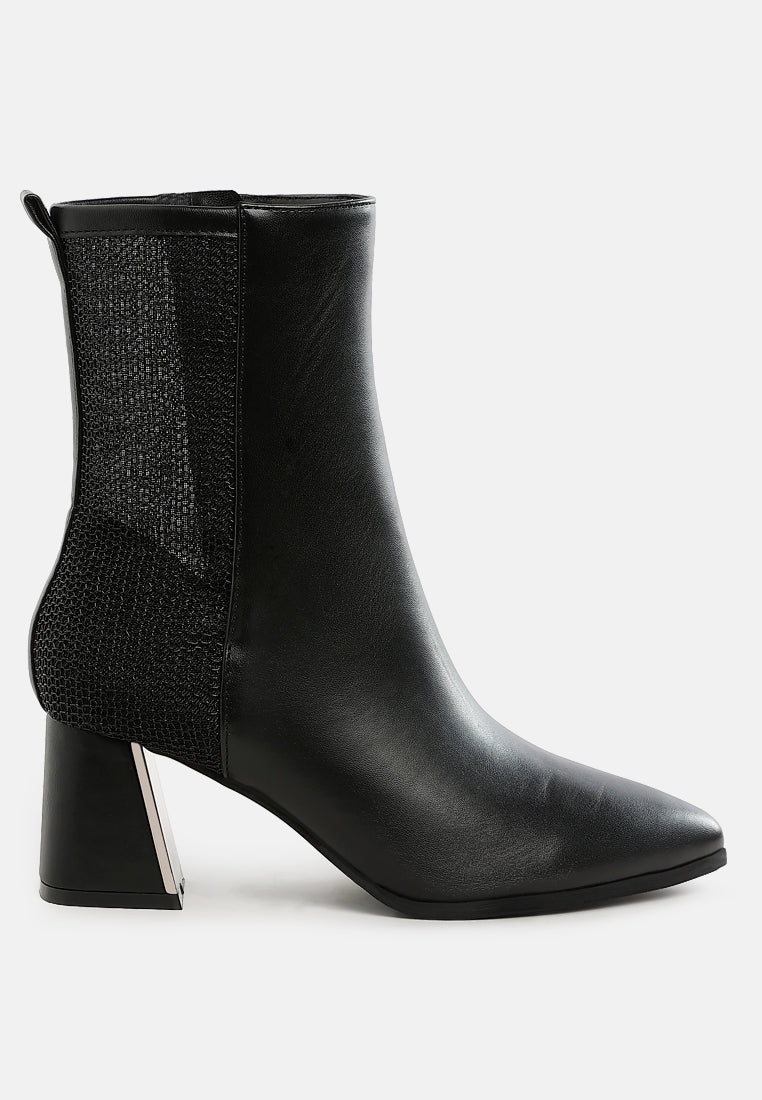 Black ankle boot with a block heel on a white background