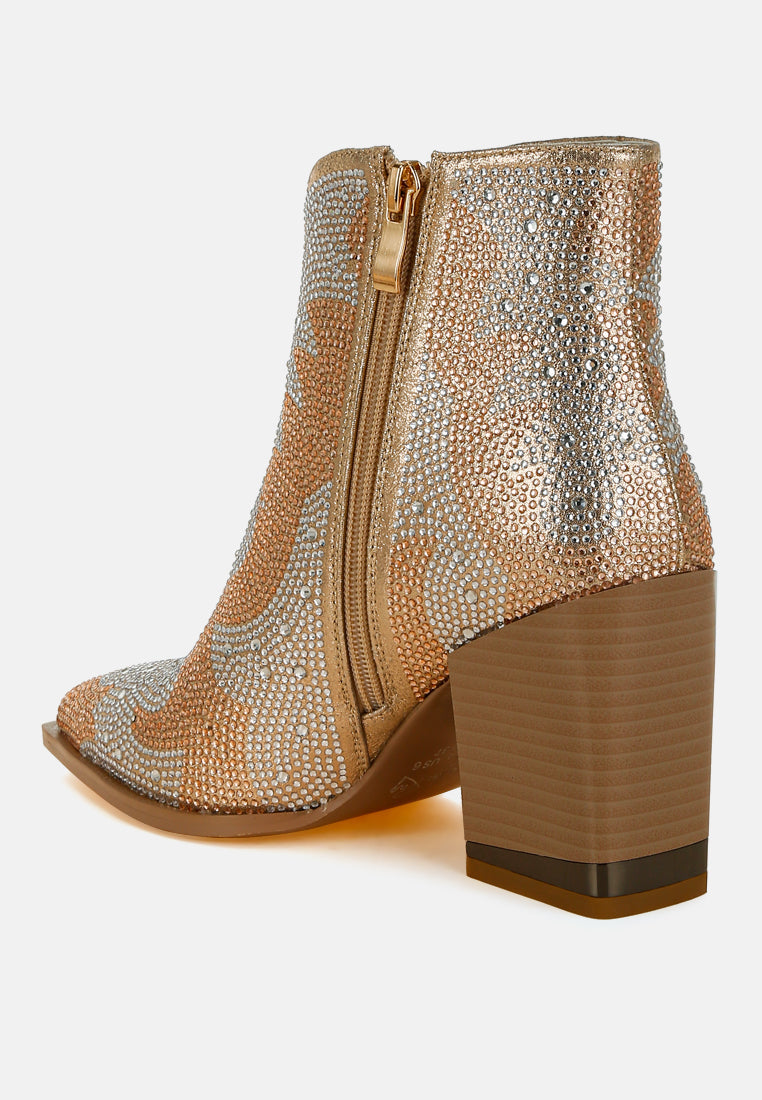 Gold embellished ankle boot with a block heel on a white background