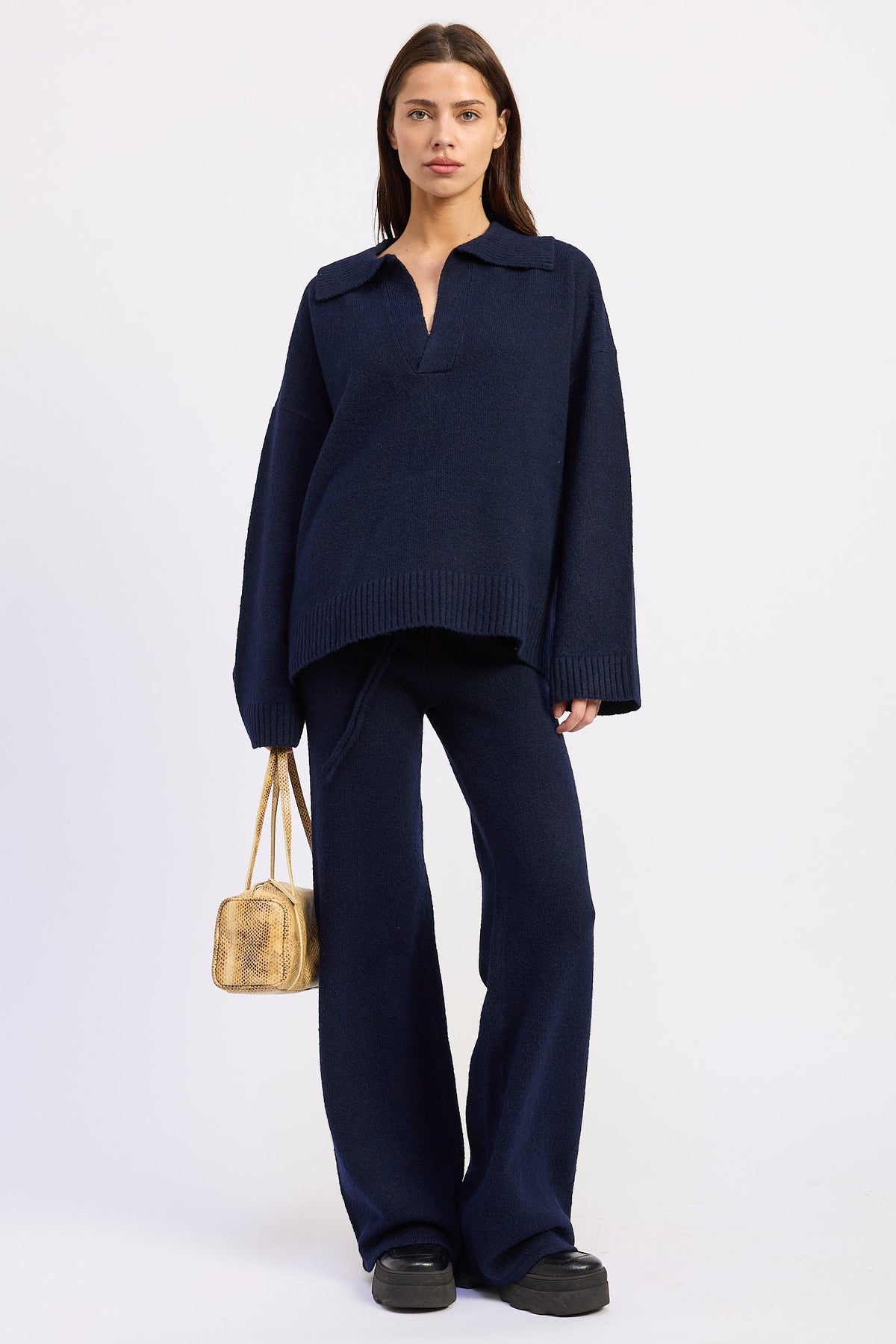 Navy wide leg knit pants styled with matching collared sweater, full front view.