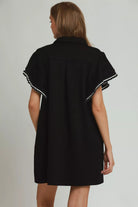 Back view of black zip collar mini dress showing clean silhouette and flutter sleeves, AVAH