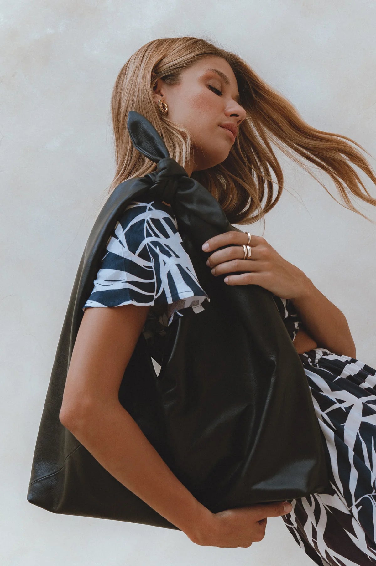 Low angle view of the Nudo Knotted Leather Shoulder Bag in black genuine leather featuring the oversized silhouette and signature knotted handle.