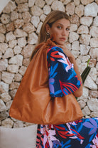 Nudo Knotted Leather Shoulder Bag in tan handcrafted leather with an oversized slouchy silhouette and knotted shoulder strap worn over the shoulder.