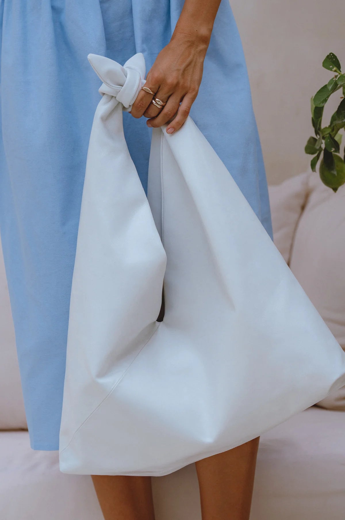 Close up of the Nudo Knotted Leather Shoulder Bag in white genuine leather highlighting the oversized shape and knotted handle.