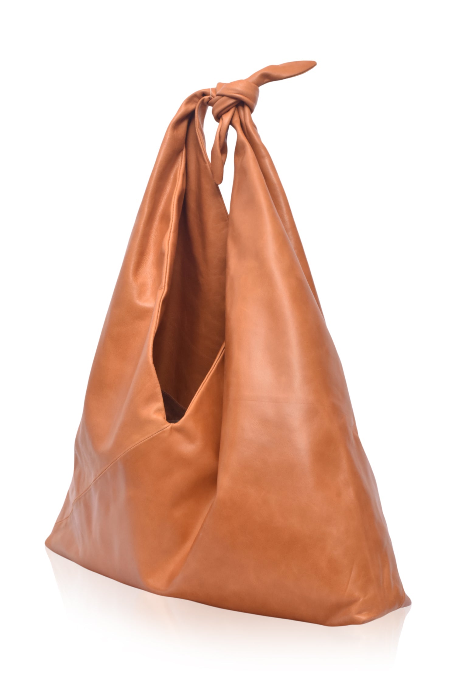 Angled view of the Nudo Knotted Leather Shoulder Bag in tan genuine leather highlighting the oversized shape and knotted shoulder strap.