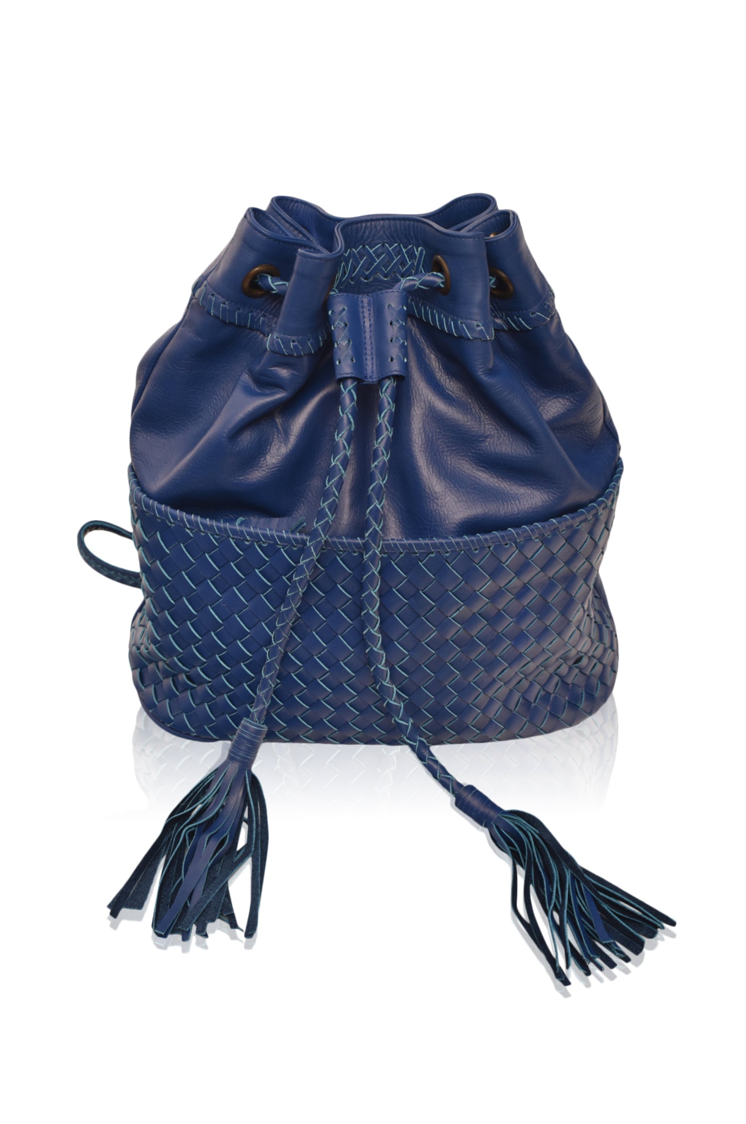 Blue leather woven backpack/handbag with braded drawstring opening with tassels and woven detail pocket on the front on white background, front view