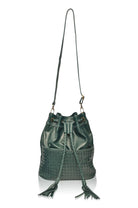 Green leather woven backpack with braded drawstring opening and braided adjustable straps converted to crossbody with brass hardware on the front on white background, front view