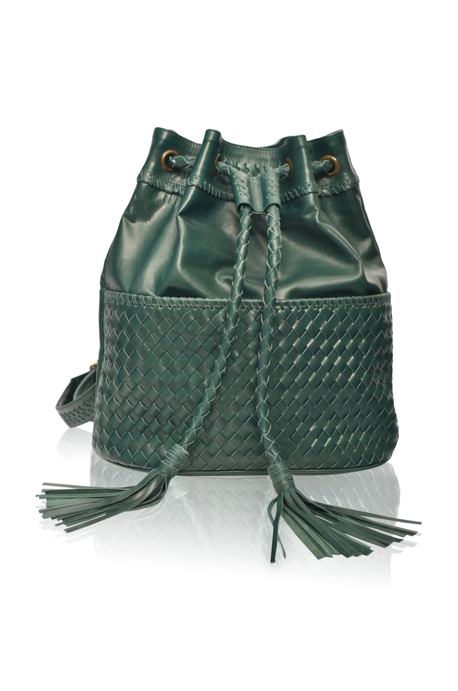 Green leather woven backpack/handbag with braded drawstring opening and braided adjustable straps with brass hardware on the front on white background, front view