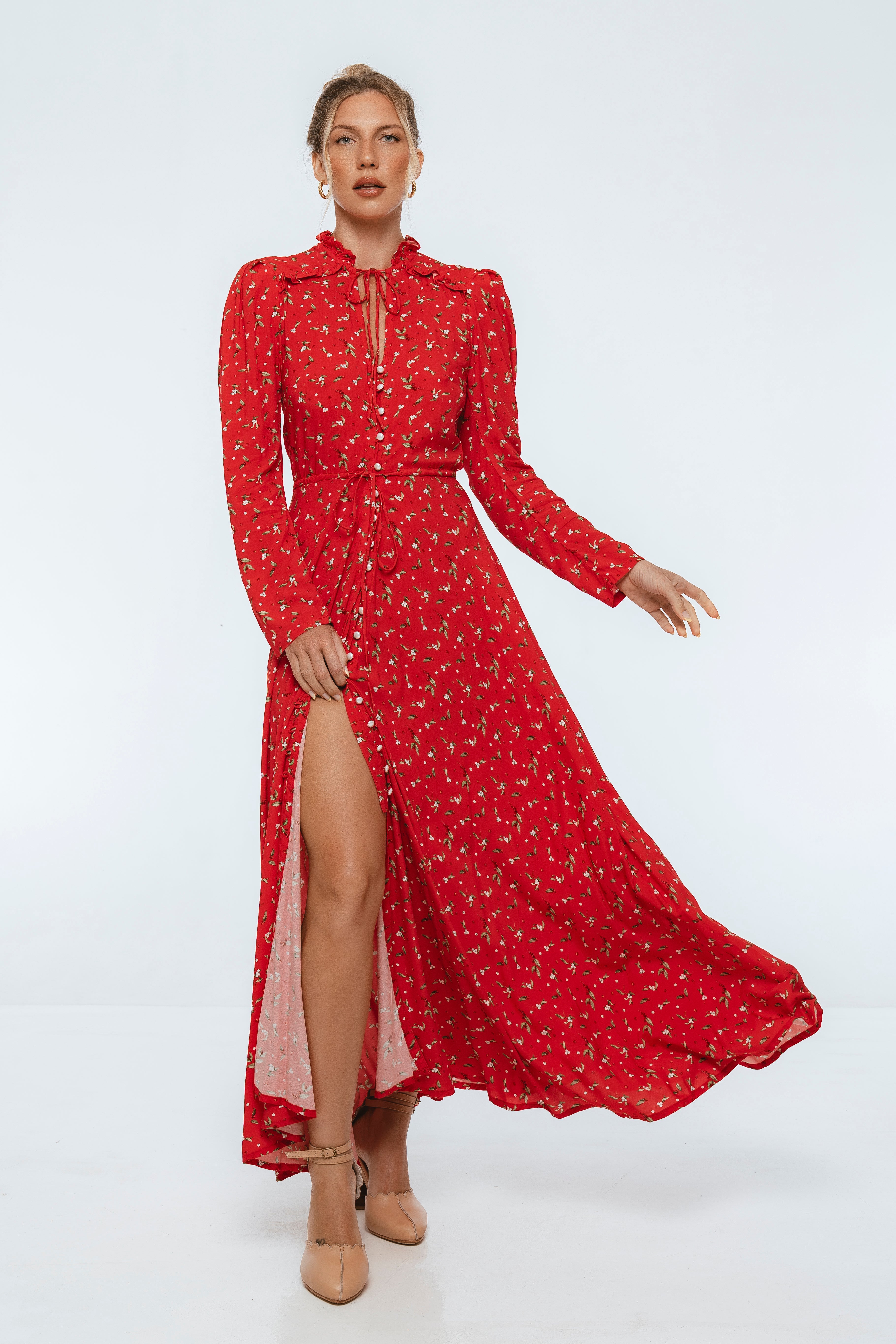 women wearing red floral midi dress with high slit with gray background