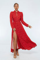 women wearing red floral midi dress with high slit with gray background