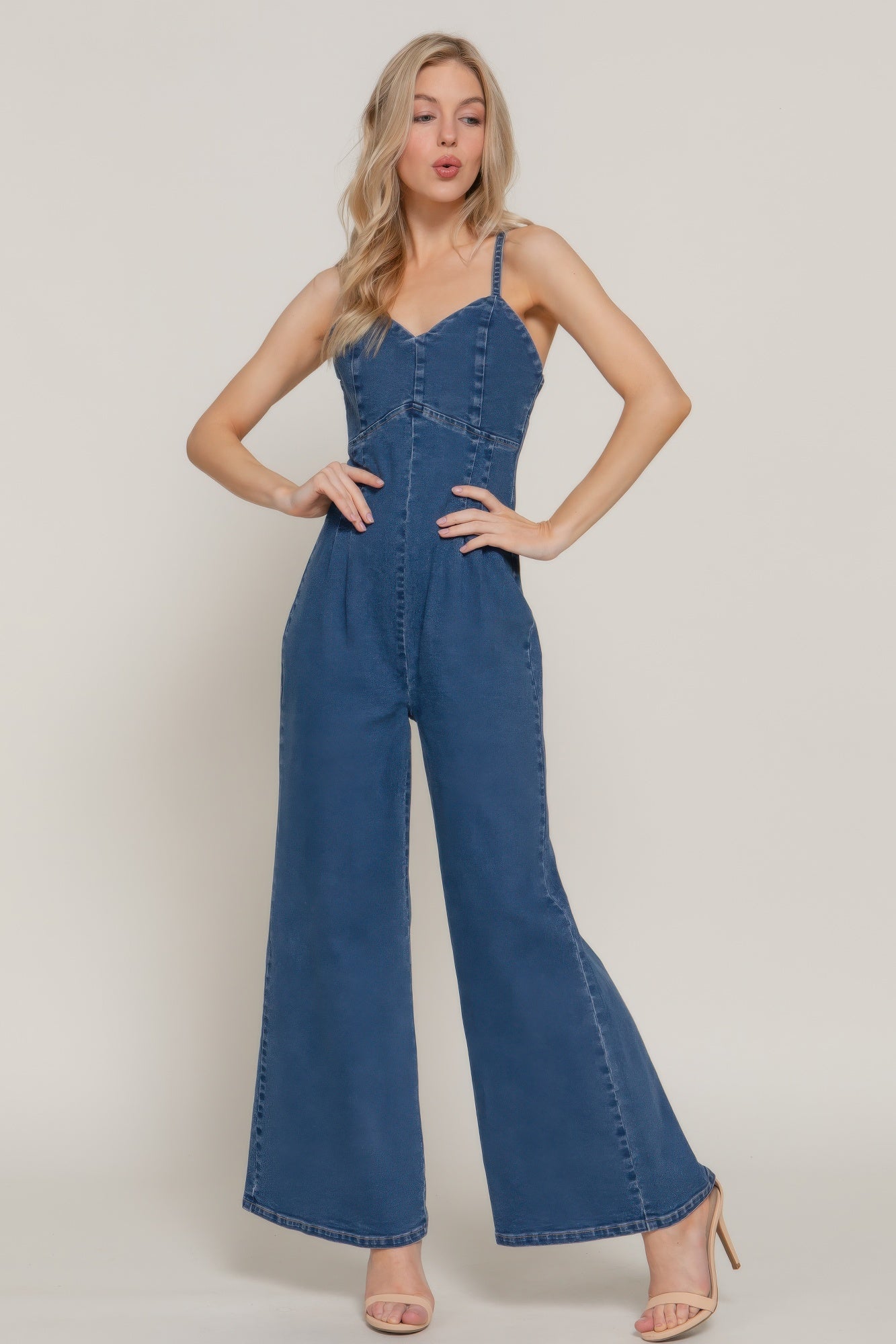 Front view of woman wearing a washed indigo wide-leg denim-look jumpsuit with spaghetti straps-AVAH