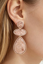 Rosewater Mosaic Drop Earrings with blush marbled stones and gold tone borders worn on the ear.
