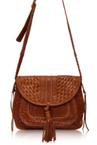 Brown leather woven handbag with a tassel on a white background