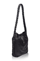 Side profile of the Sivuple Leather Shoulder Bag in black showcasing the braided leather shoulder strap and slim bucket design.
