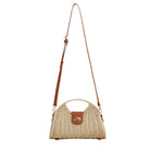 Straw crossbody bag with vegan leather and fixed top handle and removable crossbody strap complete with a fold over clasp and gold hardware, in straw front view