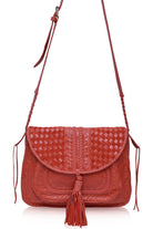 Red woven handbag with tassels on a white background